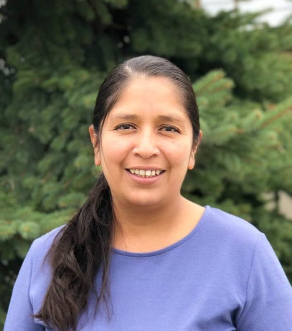 Headshot of woman with long drark straight hair wearing a blue shirt